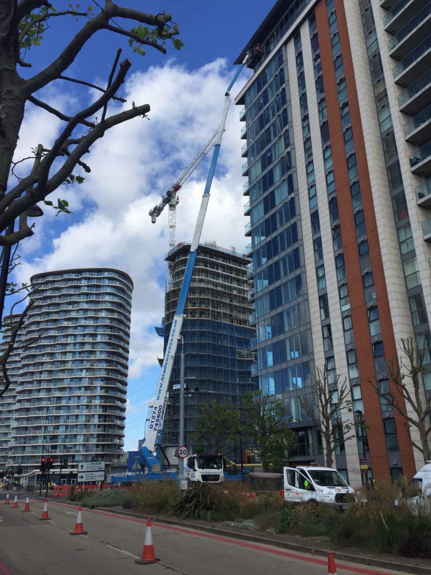 A truck mounted platform gains access to the roof of a building, pedestrians and motorists can safely pass by the work are thanks to our traffic management system