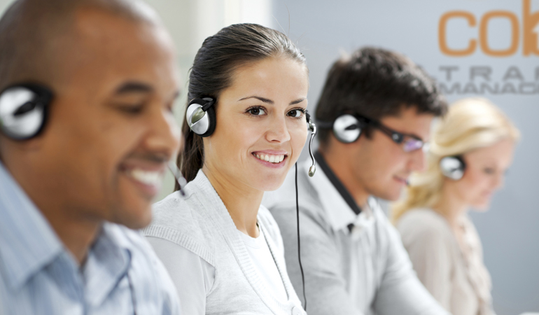 Happy female wearing headset and looking at camera.