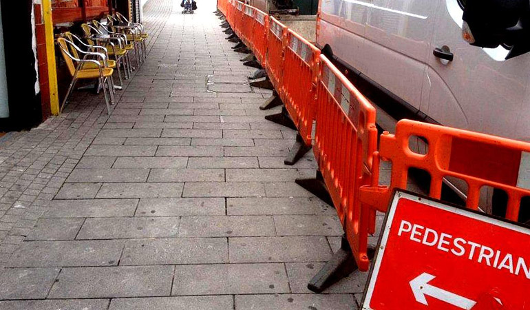 A pedestrian Control area is cordoned of so pedestrians can safely pass an ongoing traffic management site